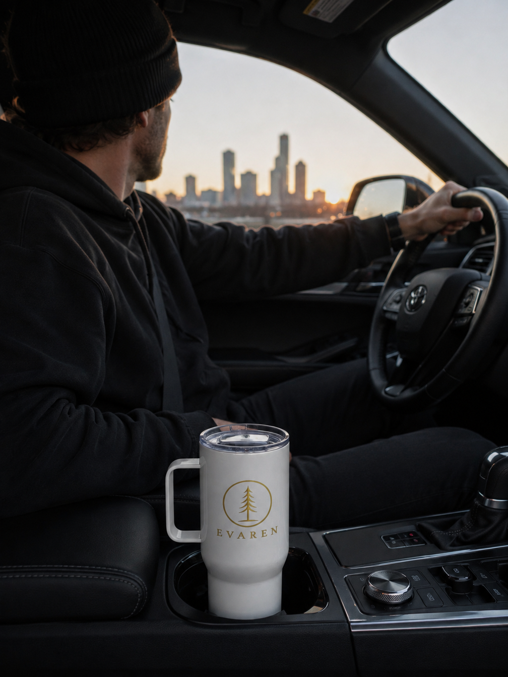 EVAREN Travel Tumbler in a vehicle cup holder during a sunset drive