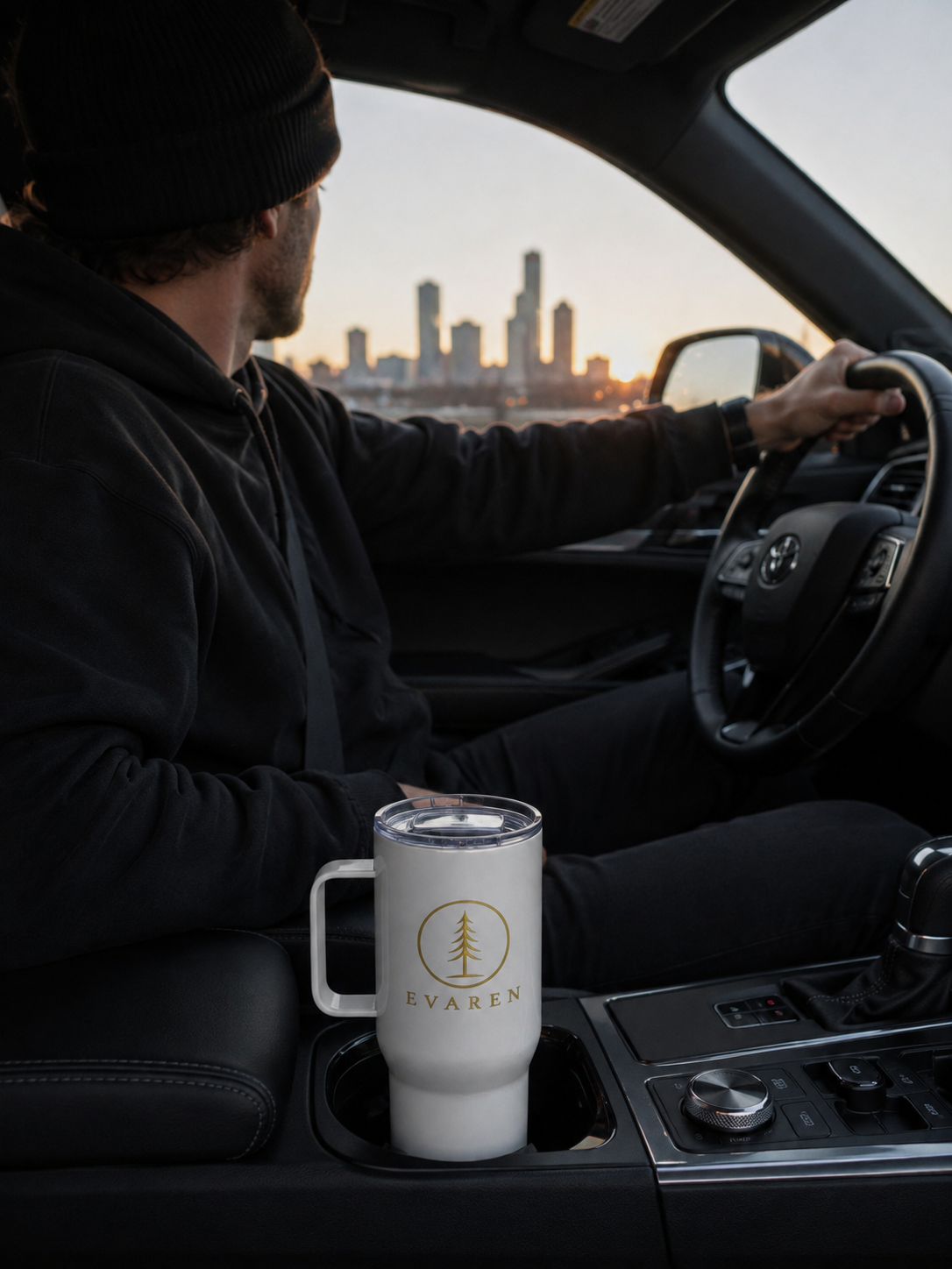EVAREN Travel Tumbler in a vehicle cup holder during a sunset drive