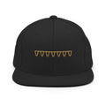 Front view of The Suspension Cap in black with muted antique-gold embroidered suspension design.