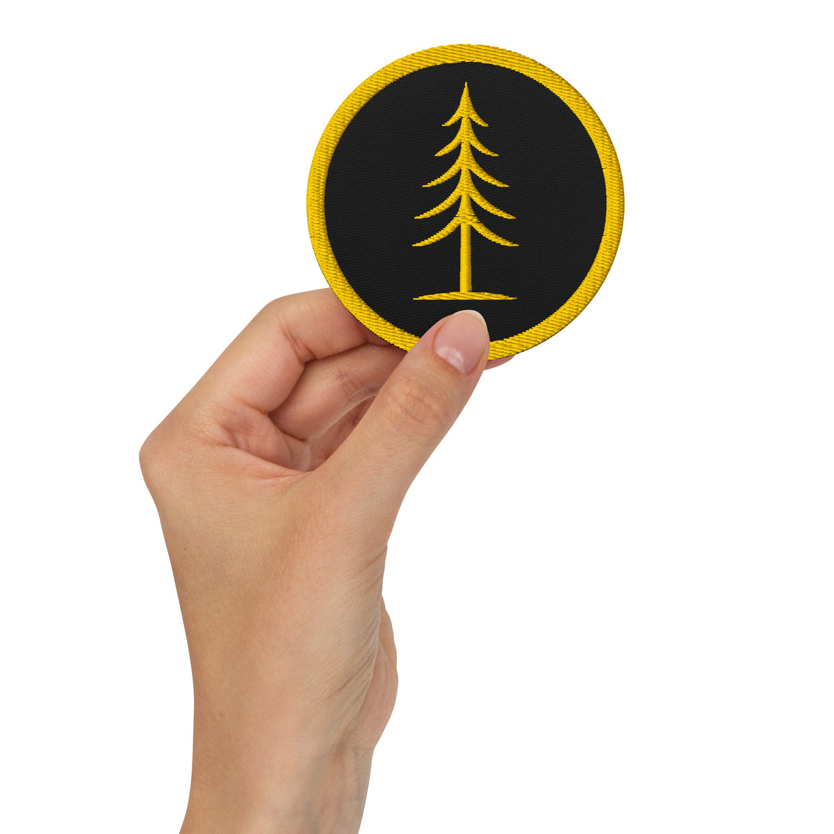 EVAREN black and gold embroidered Tree Patch held in hand to show size and detail.