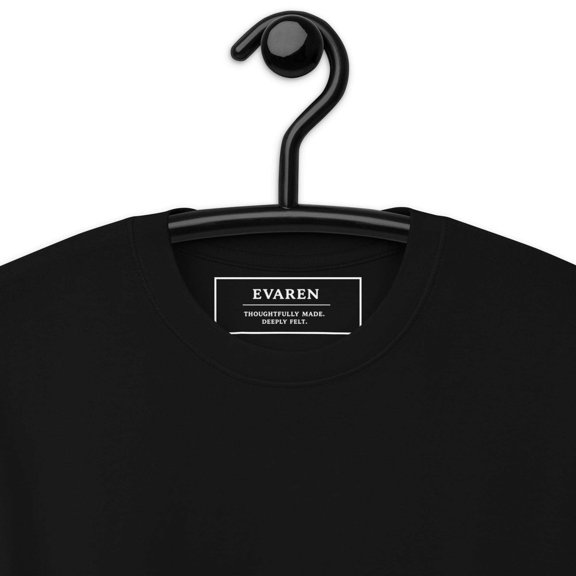 Close-up of The Interval Tee showing the custom EVAREN inside neck label and black heavyweight cotton fabric.
