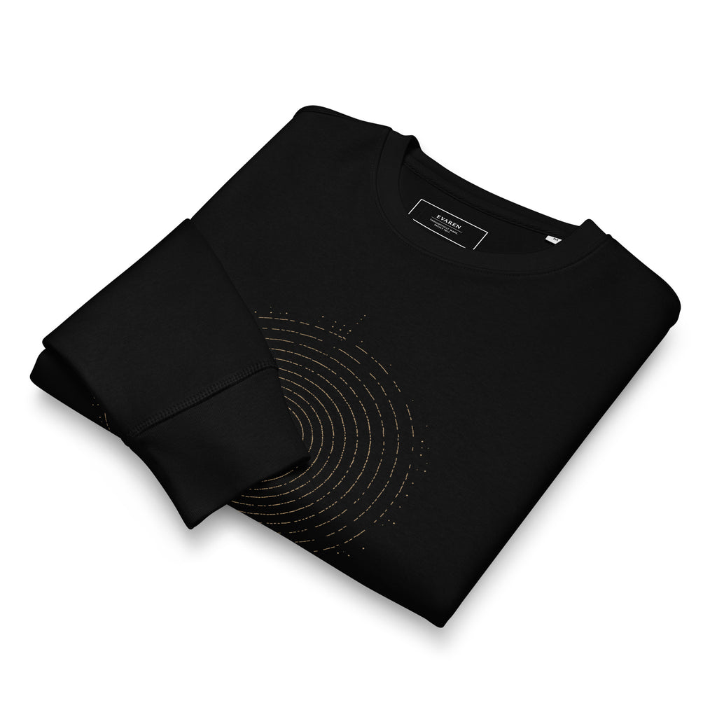 Folded black Echoes Sweatshirt showing the antique-gold concentric ring print, fabric texture, and custom EVAREN inside neck label.