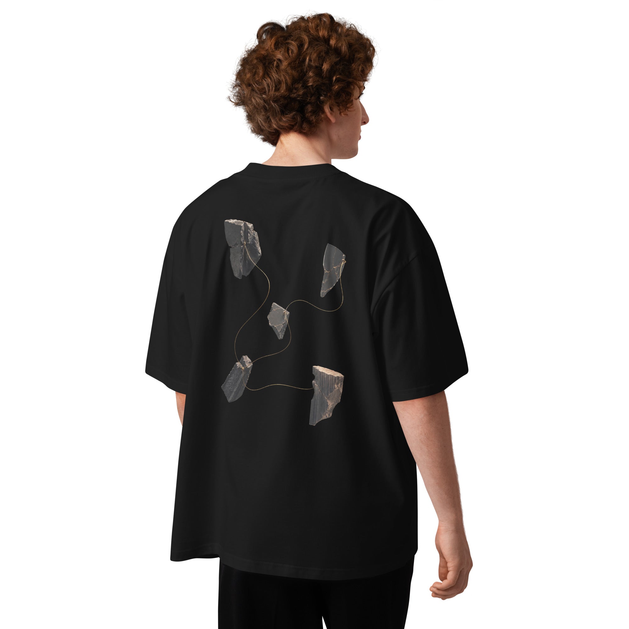The Thread Remains Tee worn by a man, showing the back graphic placement and oversized fit.