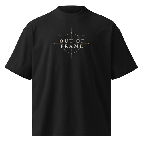Front view of the black EVAREN Out of Frame Tee with centered OUT OF FRAME artwork in muted gold and cream.