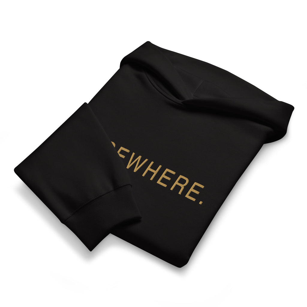 Folded black Elsewhere Hoodie showing the muted-gold flat embroidery and heavyweight fabric.