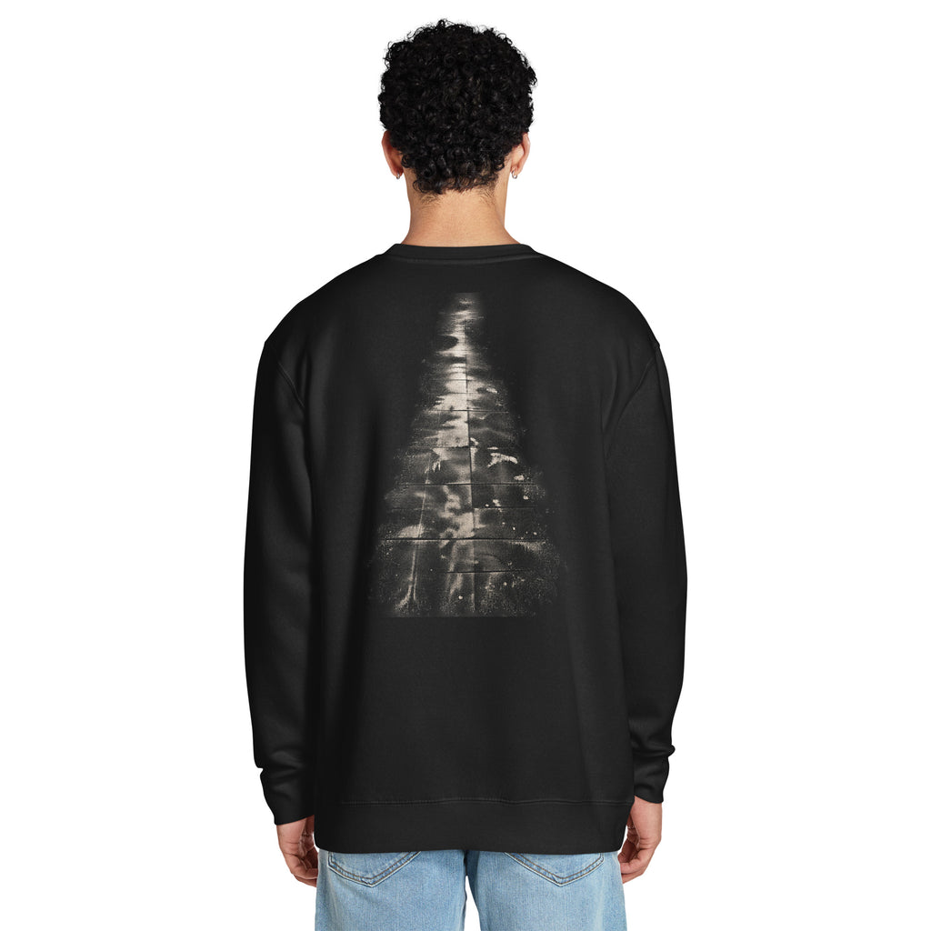 Back view of a person wearing The Witness Sweatshirt, showing the scale and placement of the abstract evergreen graphic.