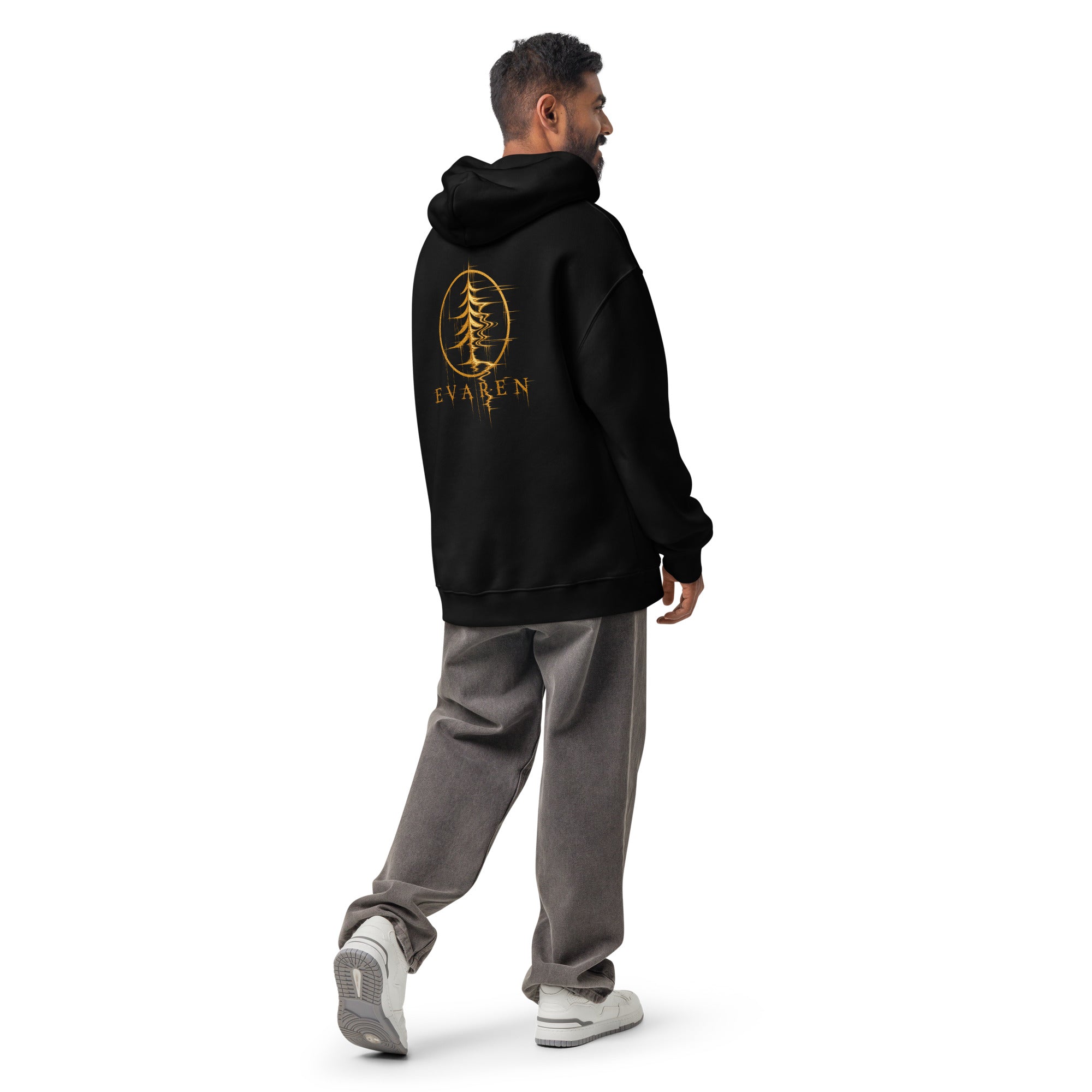 Male model wearing the black EVAREN Distortion Hoodie in an oversized fit, showing the gold graphic on the back.