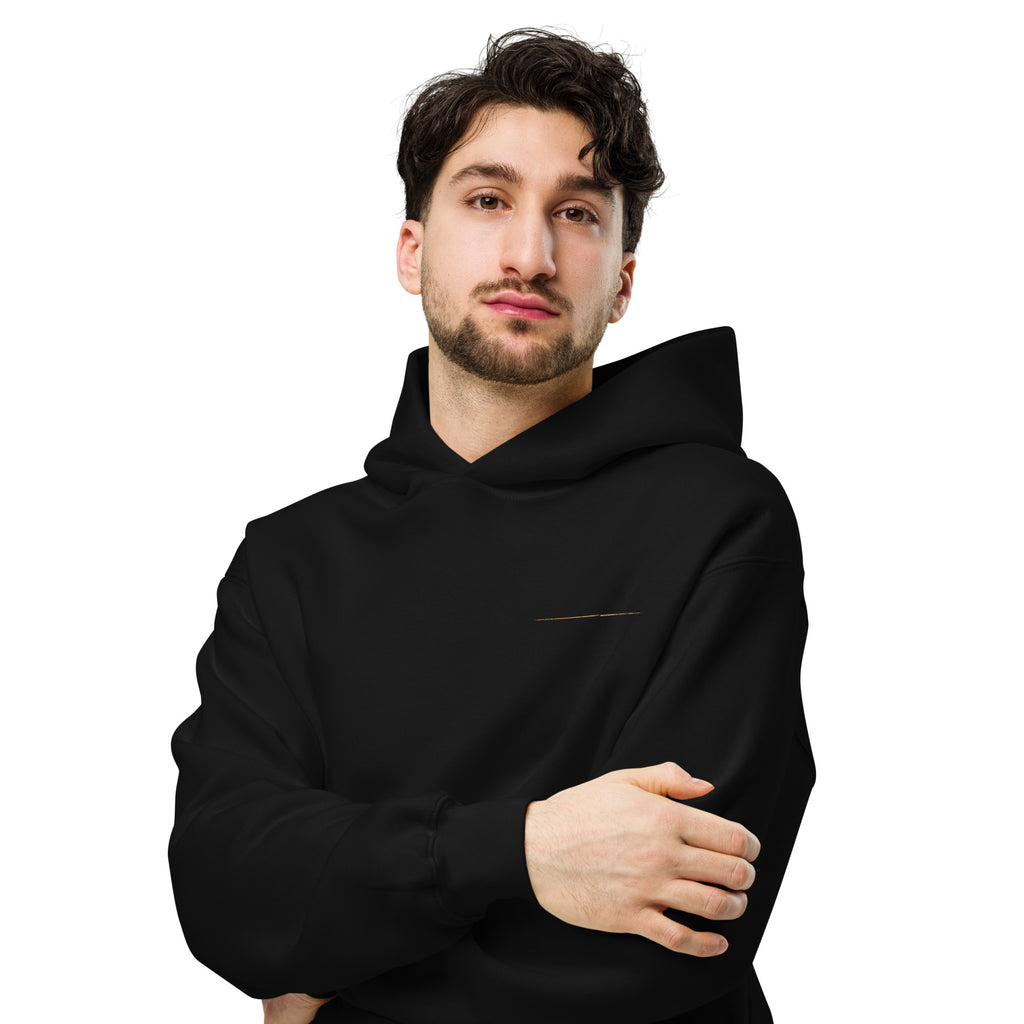 Model wearing The Break Hoodie from the front, showing the relaxed fit and subtle gold chest detail.