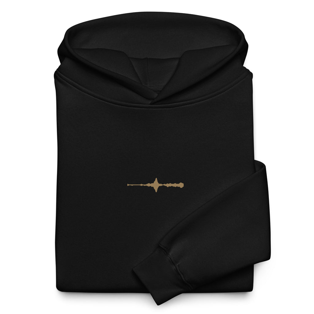 Folded black EVAREN Room Tone Hoodie showing the small muted-gold waveform on the front.