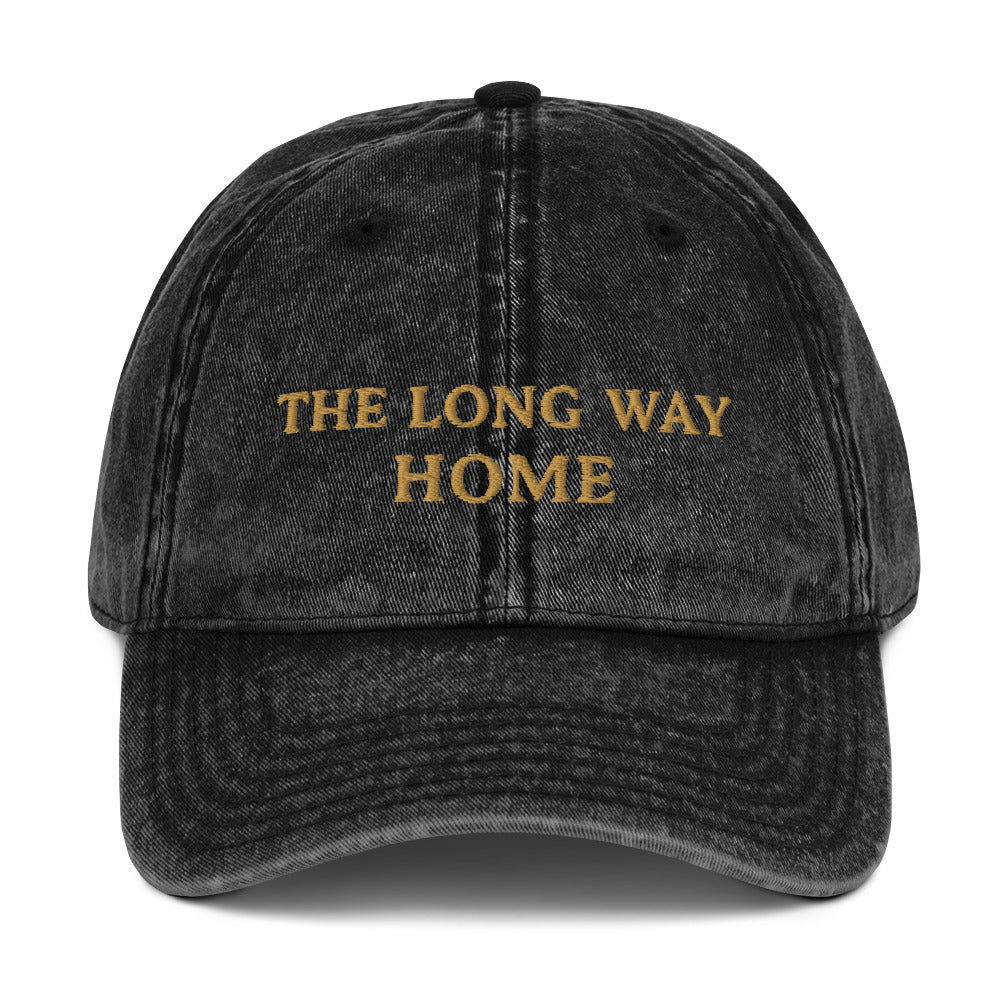 Front view of The Long Way Home Vintage Cap in washed black cotton twill with muted gold embroidery.